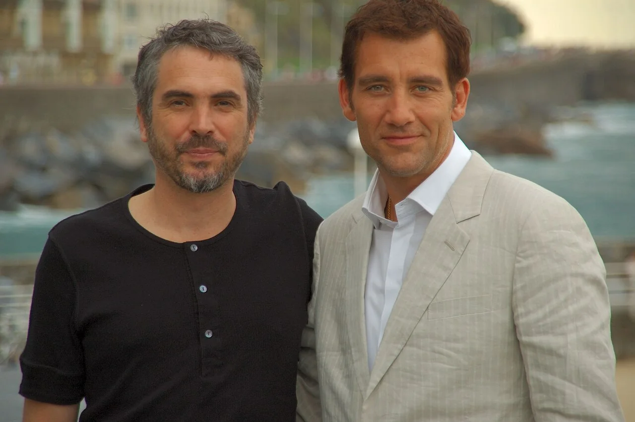 Director Alfonso Cuarón standing beside Clive Owen for a photograph.