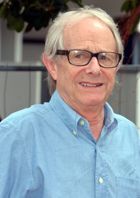 Ken Loach wearing glasses and a blue shirt at Cannes.