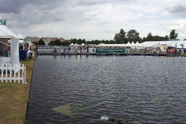 Visitors and exhibition marquees beside the Long Water at the Hampton Court Flower Show in 2005.